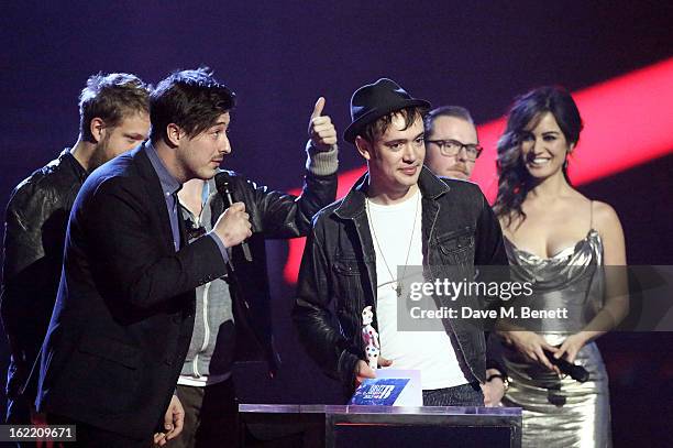 Mumford and Sons is presented with the award for Best British Group by Berenice Marlohe on stage at the Brit Awards at 02 Arena on February 20, 2013...
