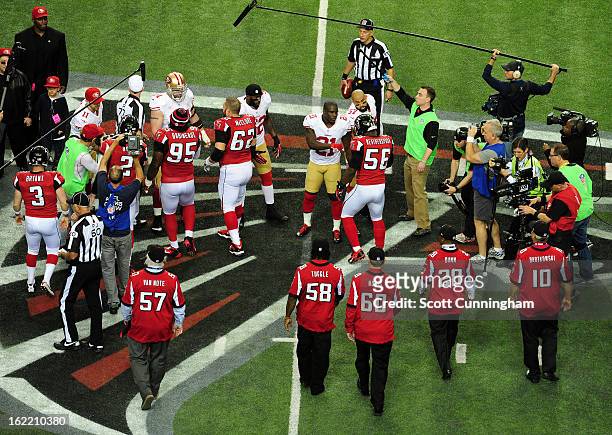 Captains of the Atlanta Falcons and the San Francisco 49ers meet at midfield for the coin toss before the NFC Championship game against at the...