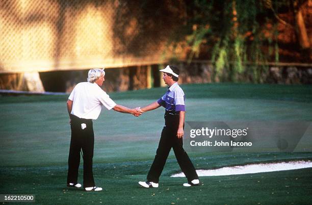 Larry Mize victorious, shaking hands after making chip on No 11 hole during playoff vs Greg Norman and winning tournament on Sunday at Augusta...