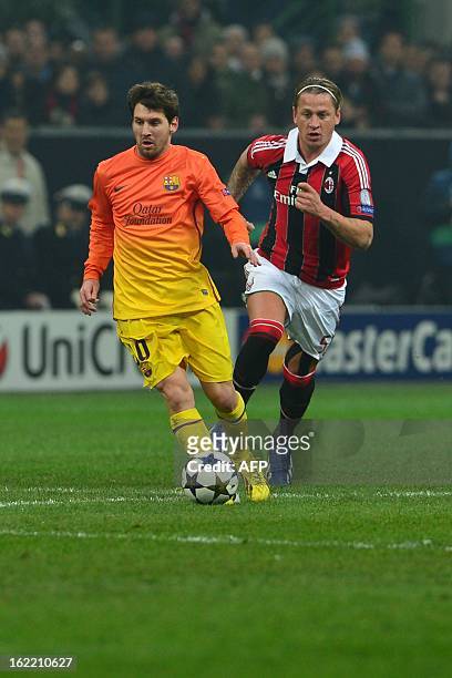 Milan's French defender Philippe Mexes fights for the ball with Barcelona's Argentinian forward Lionel Messi during the Champions League football...