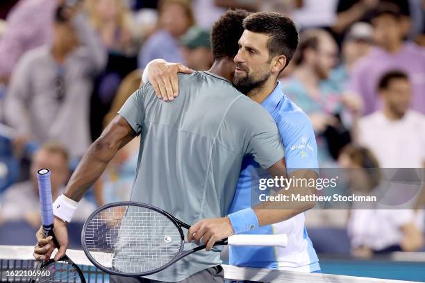 Gael Monfils of France and Novak Djokovic of Serbia meet at the net after their match during the Western & Southern Open at Lindner Family Tennis...