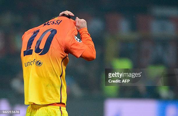 Barcelona's Argentinian forward Lionel Messi reacts at the end of the Champions League football match between AC Milan and FC Barcelona on February...