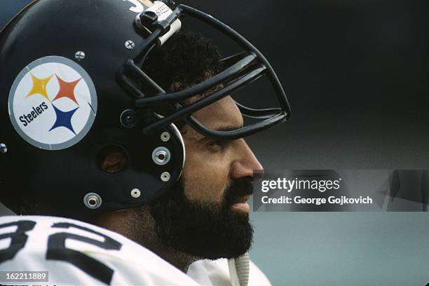 Running back Franco Harris of the Pittsburgh Steelers looks on from the sideline during a game against the Cleveland Browns at Municipal Stadium on...