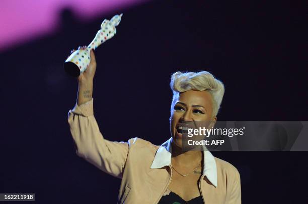British singer-songwriter Emeli Sande celebrates with the British Album of the Year award for her album 'Our Version of Events' during the BRIT...