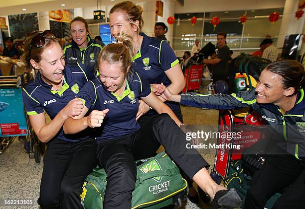 Ellyse Perry, Sarah Coyte, Alyssa Healy, Alex Blackwell and Erin Osborne of the Australian women's cricket team share a laugh after arriving home...