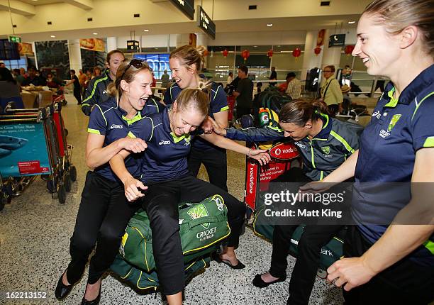 Ellyse Perry, Alyssa Healy, Alex Blackwell, Erin Osborne and Rachael Haynes of the Australian women's cricket team share a laugh after arriving home...