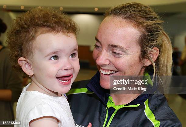 Sarah Coyte of the Australian women's cricket team shares a moment with her niece Amahni after arriving home following their win in the 2013 World...