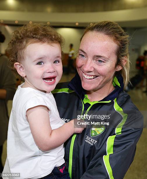 Sarah Coyte of the Australian women's cricket team shares a moment with her niece Amahni after arriving home following their win in the 2013 World...