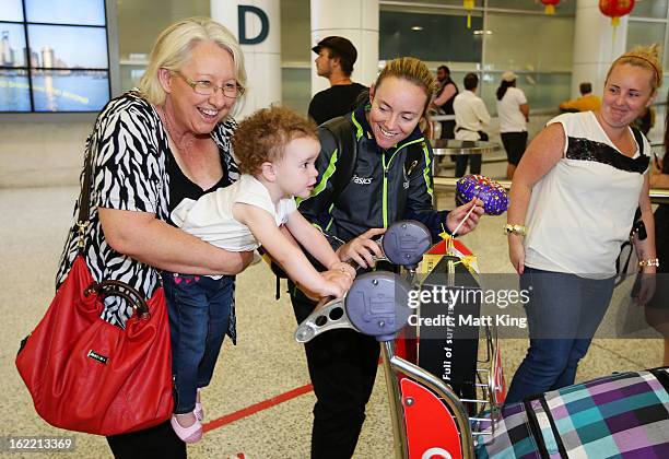 Sarah Coyte of the Australian women's cricket team shares a moment with her family after arriving home following their win in the 2013 World Cup at...