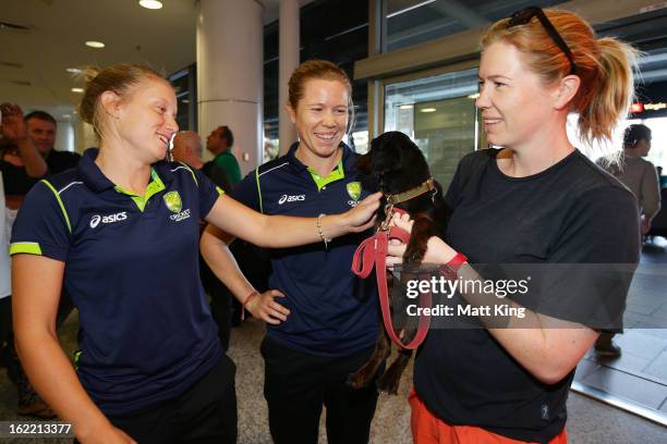 Alyssa Healy and Alex Blackwell of the Australian women's cricket team are greeted by Kate Blackwell after arriving home following their win in the...
