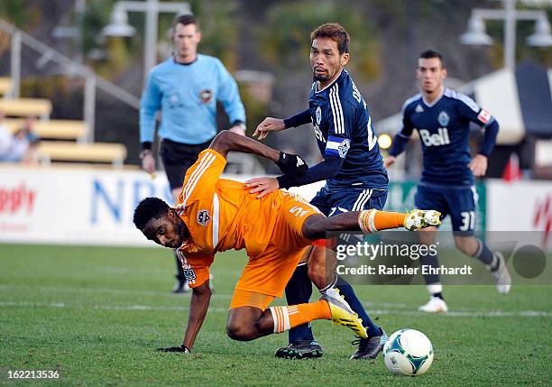 Warren Creavalle of the Houston Dynamo battles for the ball with Jun Marques Davidson of the Vancouver Whitecaps FC during the first half of a game...