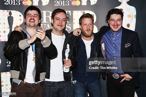 Winston-Marshall, Ben Lovett, Ted Dwane and Marcus Mumford of Mumford & Sons pose with their British Group award in the press room at the Brit Awards...