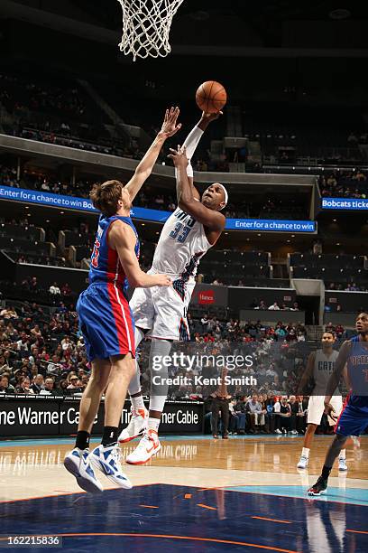 Brendan Haywood of the Charlotte Bobcats shoots against Viacheslav Kravtsov of the Detroit Pistons at the Time Warner Cable Arena on February 20,...