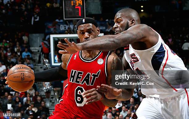 LeBron James of the Miami Heat drives against Ivan Johnson of the Atlanta Hawks at Philips Arena on February 20, 2013 in Atlanta, Georgia. NOTE TO...