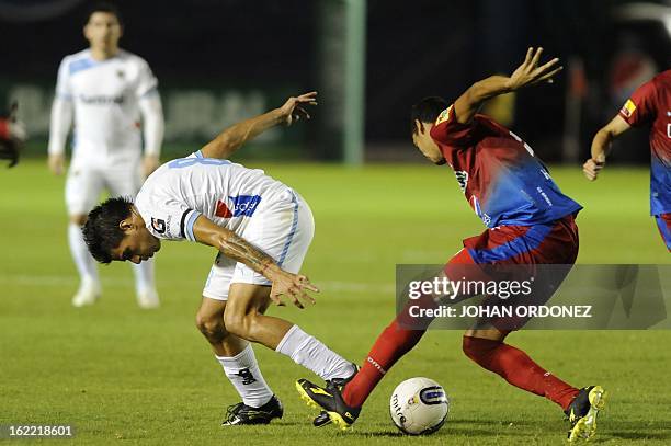 Comunicacione's Paolo Suarez vies for the ball with Municipal's Edoardo D'Gomez during their Guatemalan Closing Tournament football match at the...