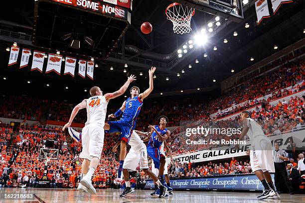 Jeff Withey of the Kansas Jayhawks shoots the ball against Philip Jurick of the Oklahoma State Cowboys during the game at Gallagher-Iba Arena on...