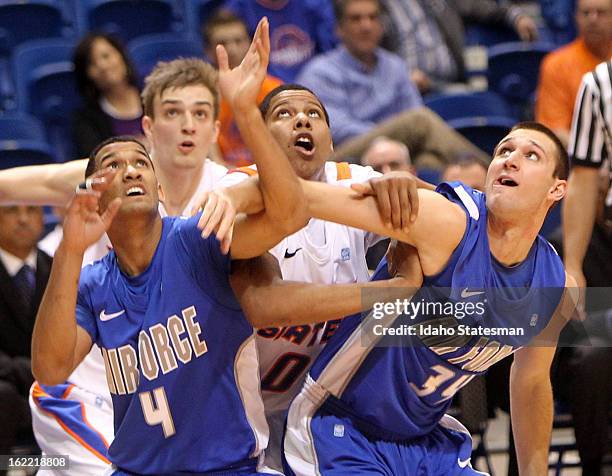 Boise State's Ryan Watkins, middle, battles for a rebound against Air Force's Kamryn Williams and Taylor Broekhuis at Taco Bell Arena in Boise,...