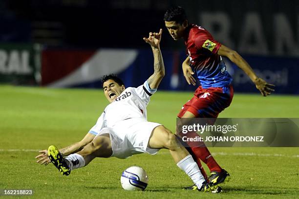 Comunicacione's Paolo Suarez vies for the ball with Municipal's Sergio Trujillo during their Guatemalan Closing Tournament football match at the...