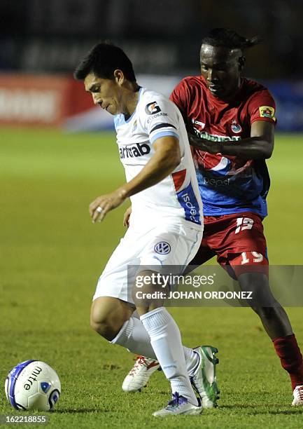 Comunicacione's Rafael Morales vies for the ball with Municipal's Marvin Avila during their Guatemalan Closing Tournament football match at the Mateo...
