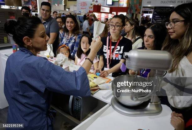 Dozens of people attend the Expo Pan at the World Trade Center in Mexico City, where suppliers of bakery and pastry tools offer their products, which...