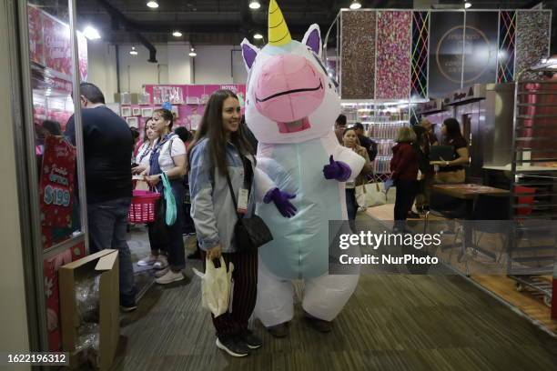 Dozens of people attend the Expo Pan at the World Trade Center in Mexico City, where suppliers of bakery and pastry tools offer their products, which...