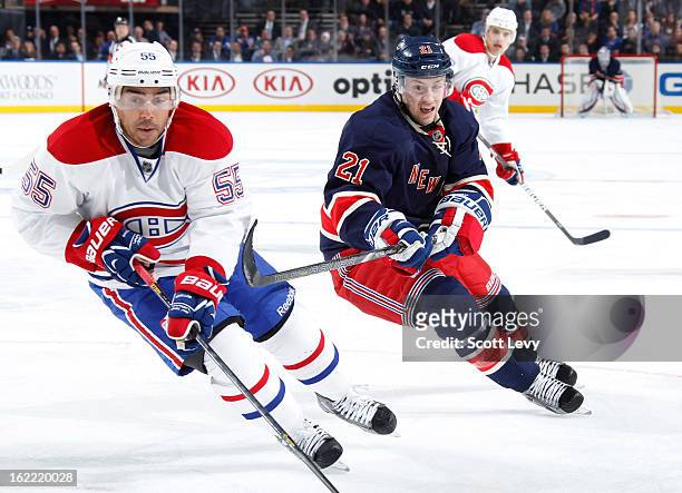 Derek Stepan of the New York Rangers skates for the puck against Francis Bouillon of the Montreal Canadiens at Madison Square Garden on February 19,...