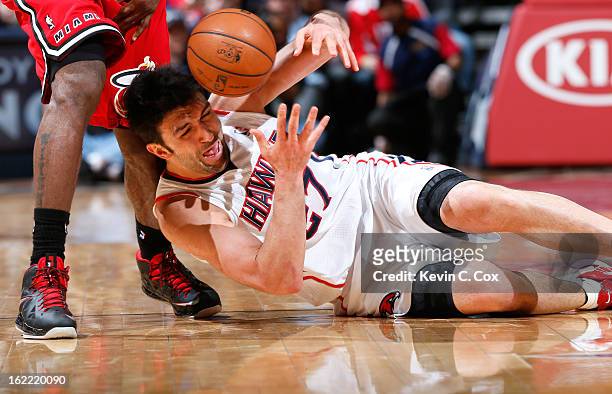 Zaza Pachulia of the Atlanta Hawks draws a foul from LeBron James of the Miami Heat as he battles for a loose ball at Philips Arena on February 20,...