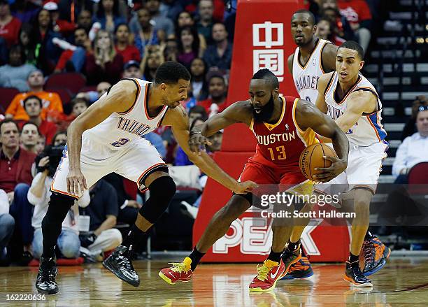 James Harden of the Houston Rockets drives against Thabo Sefolosha of the Oklahoma City Thunder at Toyota Center on February 20, 2013 in Houston,...