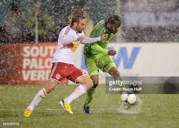 Steve Zakuani of the Seattle Sounders kicks the ball past Brandon Barklage of the New York Red Bulls at Kino Sports Complex on February 20, 2013 in...