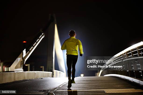 runner on bridge - copenhagen night stock pictures, royalty-free photos & images