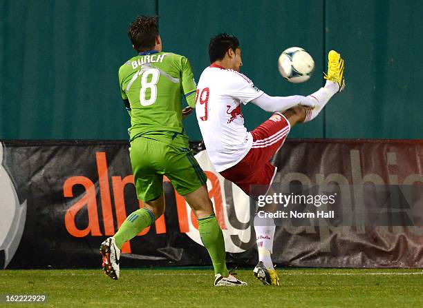 Josue Martinez of the New York Red Bulls kicks the ball over his head while being defended by Marc Burch of the Seattle Sounders at Kino Sports...