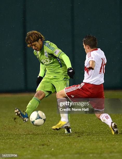 DeAndre Yedlin of the Seattle Sounders kicks the ball past defender Connor Lade of the New York Red Bulls at Kino Sports Complex on February 20, 2013...