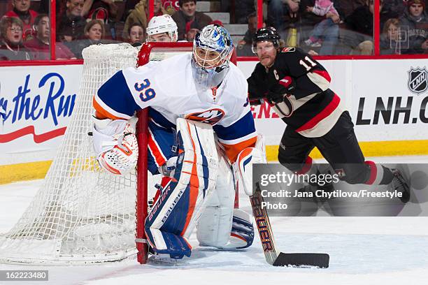 Rick DiPietro of the New York Islanders guards his net during an NHL game against the Ottawa Senators at Scotiabank Place on February 19, 2013 in...