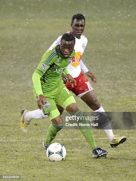 Steve Zakuani of the Seattle Sounders brings the ball up field while being defended by Lloyd Sam of the New York Red Bulls at Kino Sports Complex on...