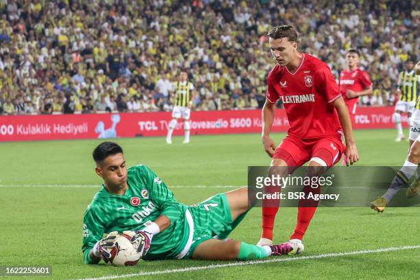 Goalkeeper Irfan Can Egribayat of Fenerbahce is challenged by Youri Regeer of FC Twente during the UEFA Conference League - Play-offs - 1st leg match...