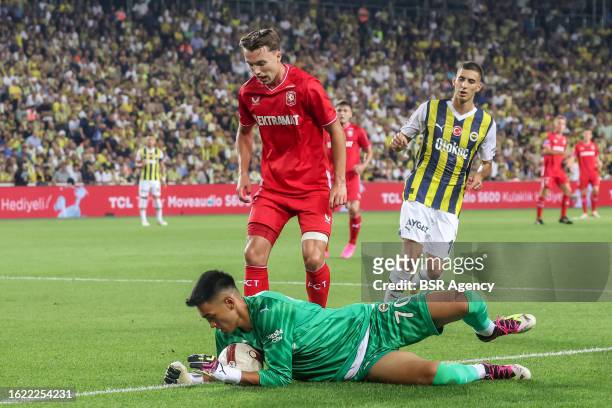 Goalkeeper Irfan Can Egribayat of Fenerbahce is challenged by Youri Regeer of FC Twente during the UEFA Conference League - Play-offs - 1st leg match...