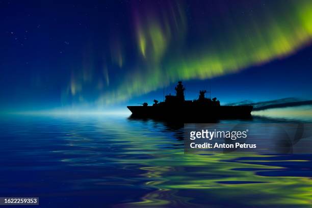 warship at sea with northern lights. frigate ship - military convoy stock pictures, royalty-free photos & images