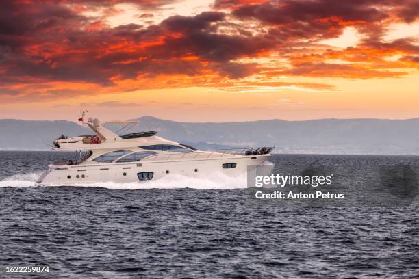 luxury motor yacht at sunset. yachting, luxury vacation at sea - motor yacht stock pictures, royalty-free photos & images