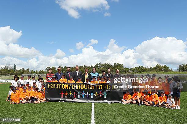 David Gallop, Sport and Multicultural Affairs Senator, Kate Lundy, Tahj Minniecon of the Wanderers and Pascal Bosschaart of Sydney pose with children...