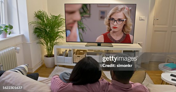 Couple watching TV at home Couple watching TV at home