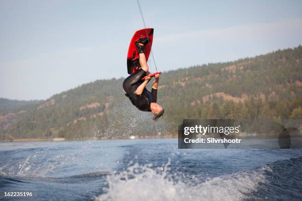 male wakeboarder in the air doing a flip - wakeboarding stock pictures, royalty-free photos & images