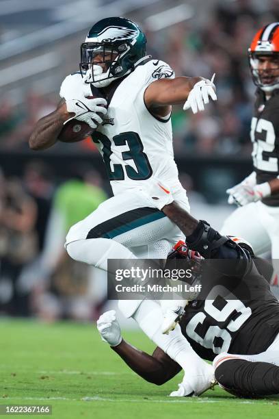 Rashaad Penny of the Philadelphia Eagles runs the ball against Jeremiah Martin of the Cleveland Browns during the preseason game at Lincoln Financial...