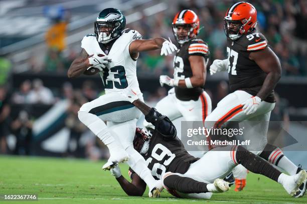 Rashaad Penny of the Philadelphia Eagles runs the ball against Jeremiah Martin of the Cleveland Browns during the preseason game at Lincoln Financial...