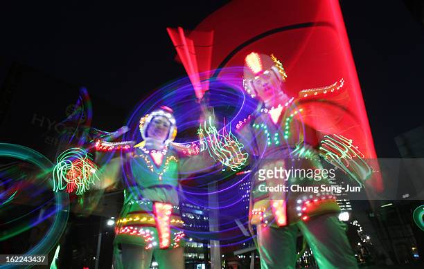 Performers spin illuminated sticks during 'Cyber Jwibulnoli' at Everland on February 21, 2013 in Seoul, South Korea. Jwibulnoli is originally played...