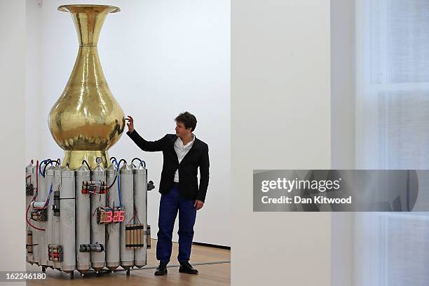 Artist Adel Abdessemed stands beside his sculpture entitled 'Le Vase abominable' 2013, at the David Zwirner Gallery on February 21, 2013 in London,...