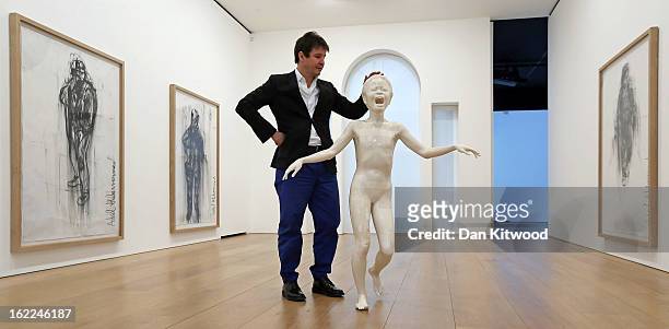 Artist Adel Abdessemed stands beside his sculpture entitled 'Cri' 2013, at the David Zwirner Gallery on February 21, 2013 in London, England. The...