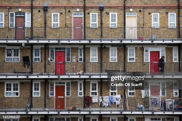 Woman looks out from a residential development in the London borough of Tower Hamlets on February 21, 2013 in London, England. A recent study has...