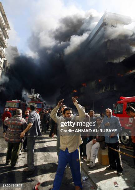 An Iraqi gestures as he evacuates the site where a car bomb exploded in central Baghdad 12 February 2007, ripping through popular Shiite market areas...