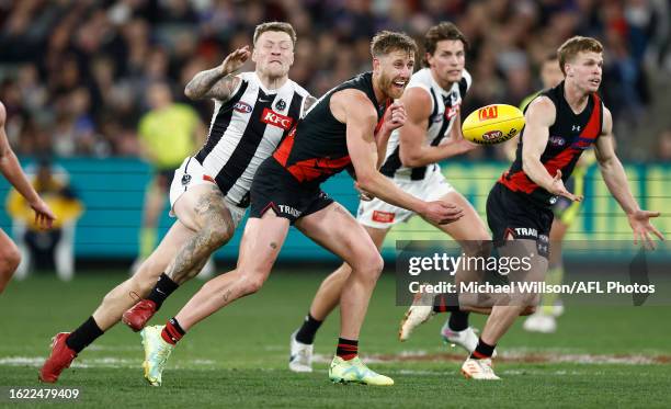 Dyson Heppell of the Bombers is tackled by Jordan De Goey of the Magpies during the 2023 AFL Round 24 match between the Essendon Bombers and the...