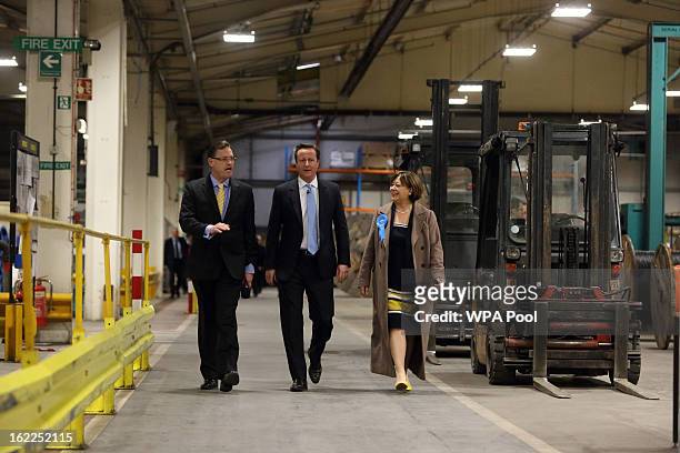 British Prime Minister David Cameron walks through the factory floor with local Conservative candidate Maria Hutchings and Paul Atkinson CEO of...